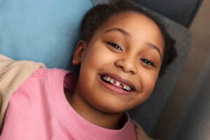 tooth extraction process with girl smiling